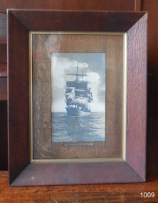 Photograph in wooden frame, gilt inner frame, bark matte. Inscription below photograph and on back
