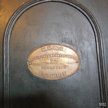 Oval brass plaque on top left panel has maker's name and address