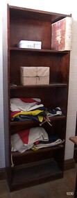 Set of five wooden shelves that has been stained a dark brown.