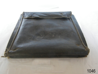 Black leather or similar fabric bag with wide side seams and flap