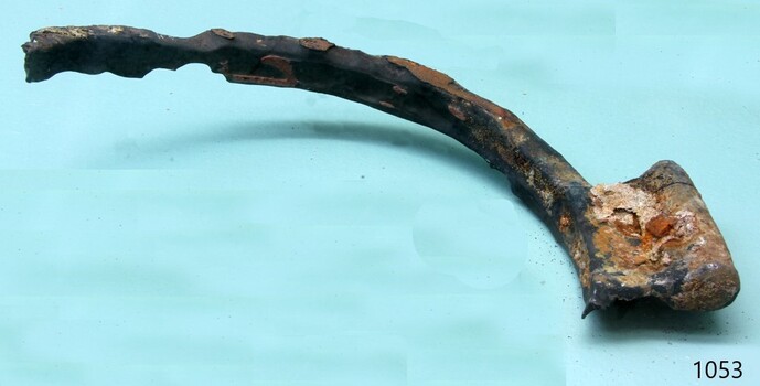 Metal of the frame has missing parts and is encrusted and corroded