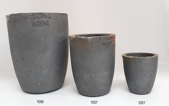 Three crucibles of different size but similar grey material and design