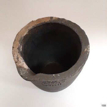 The sides are thick, there is a pouring lip on the rim and a little accumulation of matter