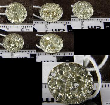 Six diamond-like buttons on a flat surface