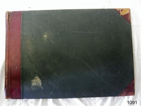 Hardcover rectangular book with pre-printed columns and rows on the pages