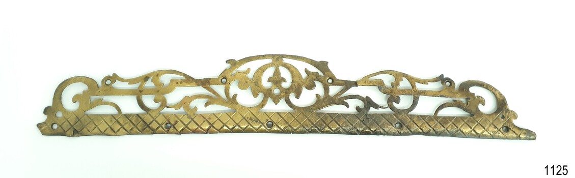 Brass fancy work step tread protector. Base has mounting holes drilled through