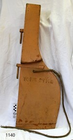 Blond timber rudder with brass fitting s and attached spliced thin rope