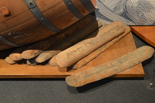 Ingots on display near the barrel and cargo nets