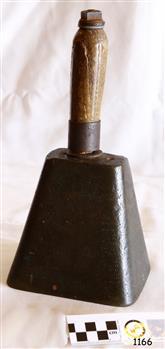 An oblong metal bell with a wooden handle.