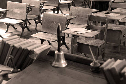 Photograph of schoolroom showing bell on teacher's desk.