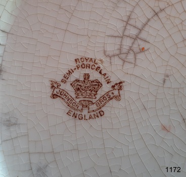 Brown stamp on base of bowl has maker's emblem and mark