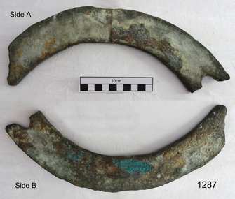 Two curved sections shaped metal with corrosion on the surface