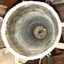 View from mouth to base, with white chalky rings on the inside metal and a hole in the base