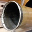 Mouth of base, side on, with white rim inside and out, and dark metal down the inside and next to the outside white ring