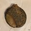 Reverse is fragile, encrusted, with a large chip broken from the surface