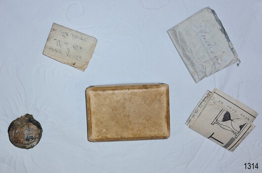 Metal watch, cardboard box and three documents on the table 