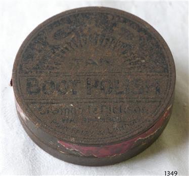Brown round tin with black print on the lid