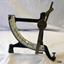 Metal scale on a metal stand with silver coloured measuring scale on front