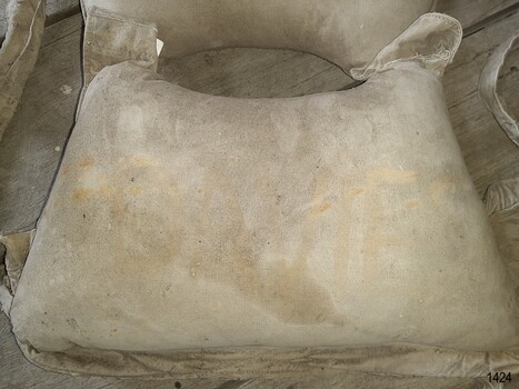 Inscription painted onto canvas, barely visible