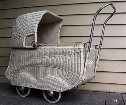 Doll's pram, white painted basketwork body, four wheels and tubular metal handle.