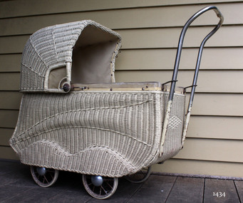 Doll's pram, white painted basketwork body, four wheels and tubular metal handle.