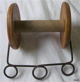 Wooden reel wit metal handle attached