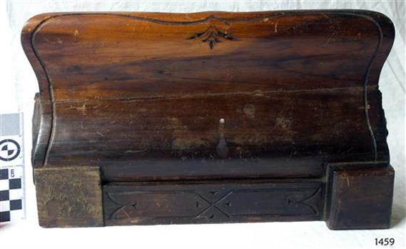 Decorative carving around the border of the pen tray.