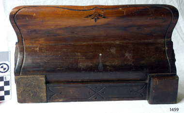 Decorative carving around the border of the pen tray.