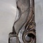 Decorative scroll carved into side