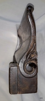 Decorative scroll carved into side