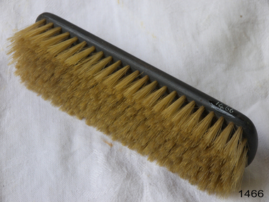 Wooden brush on its side showing blonde brissles