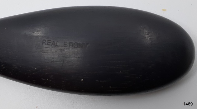 Inscription embossed into surface of handle