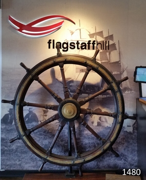 Large wooden ship's wheel with ten spokes