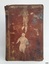 Burgundy hardcover with gold embossed letters on spine. Pasted clippings are on cover and sping.