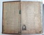 Newspaper clippings cover the inside cover and fly page