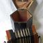 Concertina on bench in front of its open wooden box