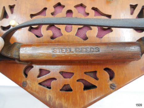 Close-up of inscription stamped into timber under handle