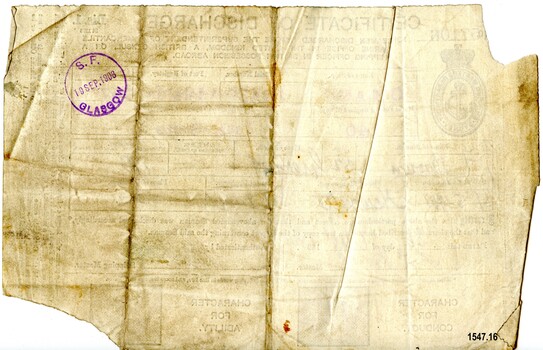 Back of discharge cerificate showing round red stamp with date and place