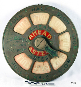 Metal dial with inlaid red sections. Text is on both the metal and the inlaid parts.
