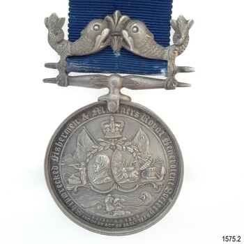 Silver metal hangs from a silver bar with a fleur de lies between two fish. Text surrounds a variety of images.