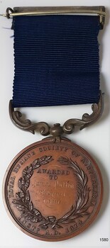 Medal has printed lettering and wreath, enclosing engraved details of recipient and date