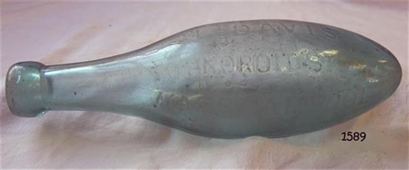 Glass bottle with pointed base and oval shaped body