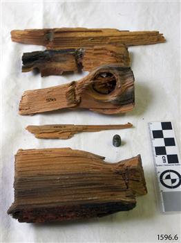 Several pieces of broken timber, and a bullet that was found within the timber