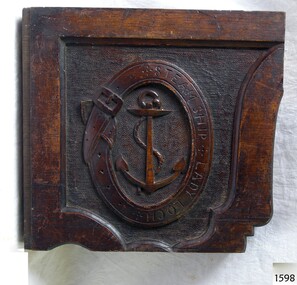 Wooden panel carved with a logo of a Belt enclosing an anchor