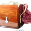Case is closed with a brass hook fitting. Timber is highly polished. A leather carry strap is attached.