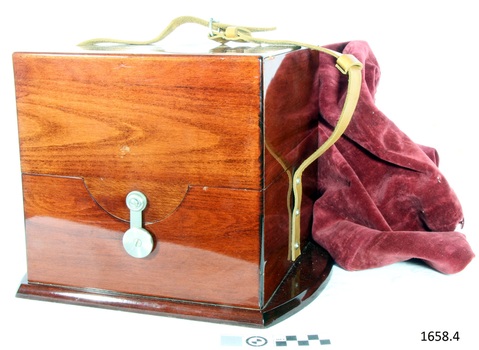 Case is closed with a brass hook fitting. Timber is highly polished. A leather carry strap is attached.