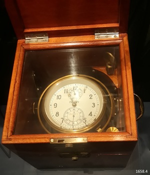 Chronometer face has two small dials on the larger face. The face has analogue numbers.