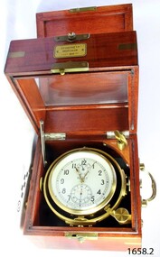 Chronometer's fitted case is medium coloured timber. Chronometer is enclosed in brass.