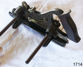 Cast steel wood working plane with wooden saw type handle and Japanned metal work