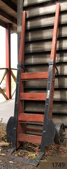 Wooden frame and metal supports; wood is painted orange